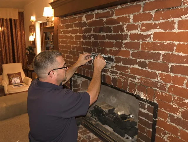 Town 'n' Country Chimney Sweep expert fixing a fireplace in Town 'n' Country, FL